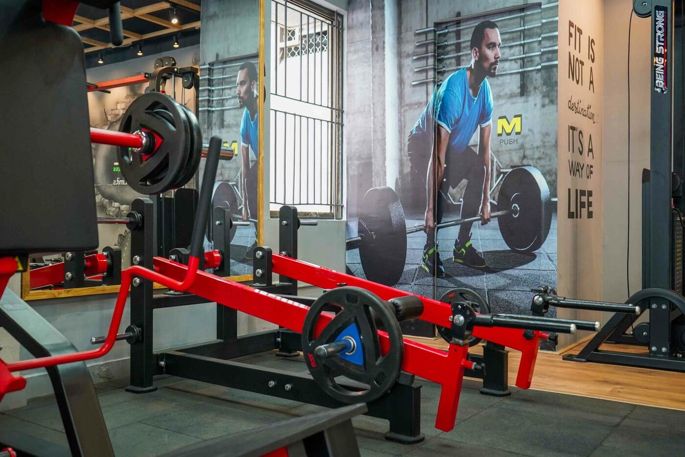 Deadlift platform beneath the athlete mural