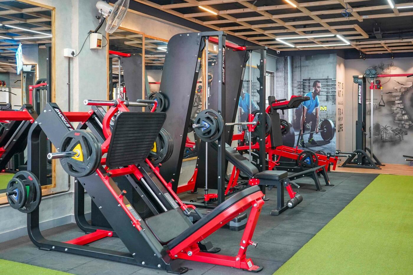 Leg press machines standing on green turf