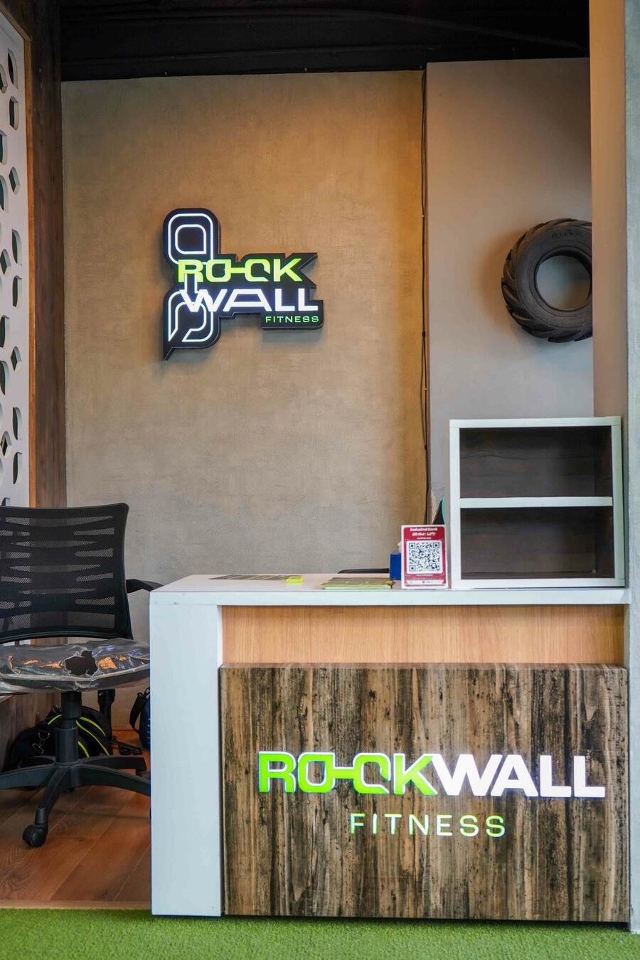 Reception desk under the neon Rockwall sign